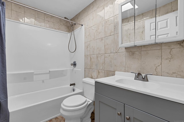 full bathroom featuring vanity, shower / bath combo, tile walls, and toilet