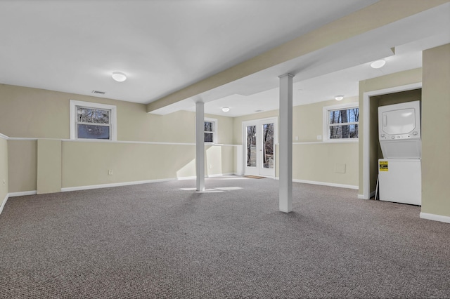 basement with carpet floors and stacked washer and clothes dryer