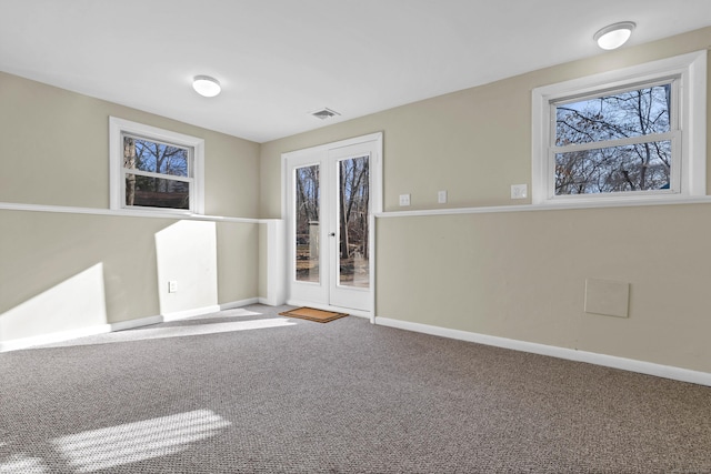 carpeted empty room with french doors