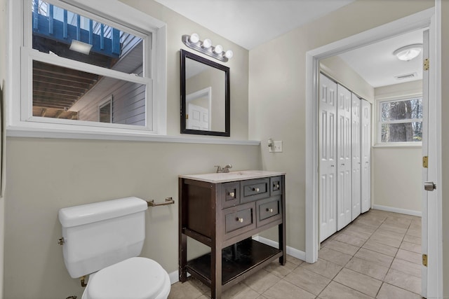 bathroom featuring tile patterned flooring, vanity, and toilet