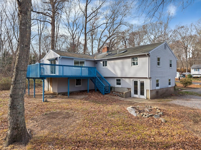 back of property featuring a wooden deck and french doors