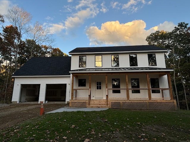 view of front of property with a porch and a lawn