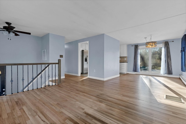 empty room with light hardwood / wood-style flooring and ceiling fan