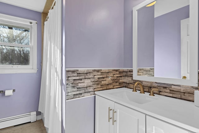 bathroom with baseboard heating, tile patterned floors, and vanity