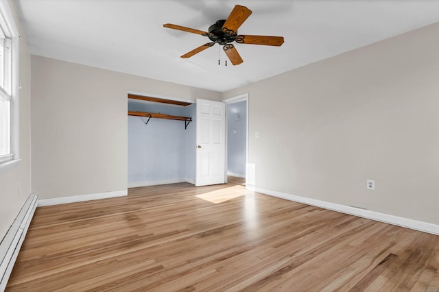 unfurnished bedroom with ceiling fan, a closet, a baseboard radiator, and light hardwood / wood-style floors