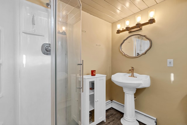 bathroom featuring a baseboard heating unit, sink, wooden ceiling, hardwood / wood-style floors, and a shower with shower door