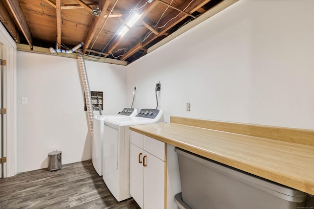 washroom featuring washer and dryer, cabinets, and dark wood-type flooring