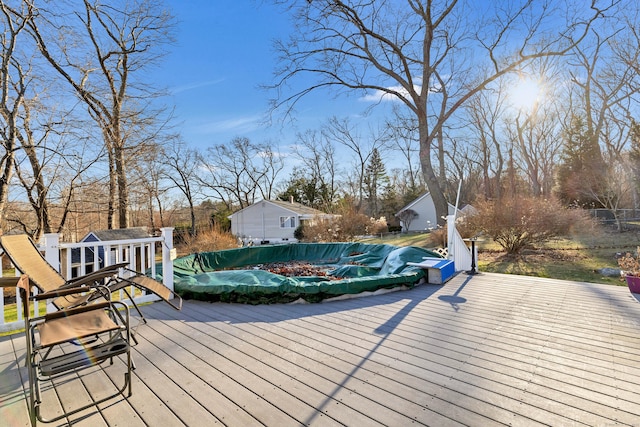 deck featuring a covered pool