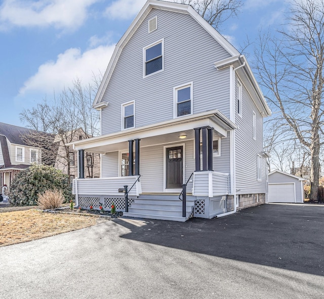 front facade featuring covered porch, an outdoor structure, and a garage