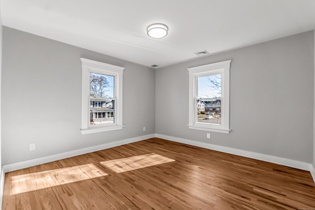 spare room with hardwood / wood-style floors