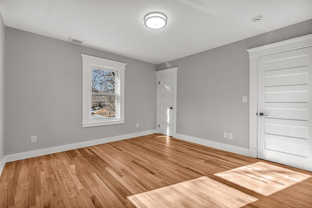 unfurnished room featuring hardwood / wood-style floors