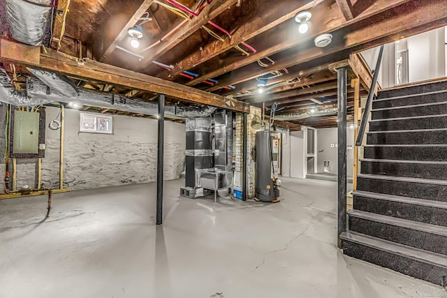 basement with electric panel, heating unit, and water heater