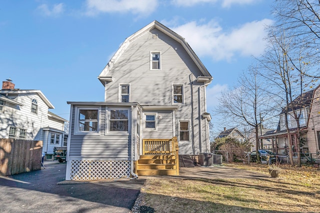 rear view of house featuring central AC