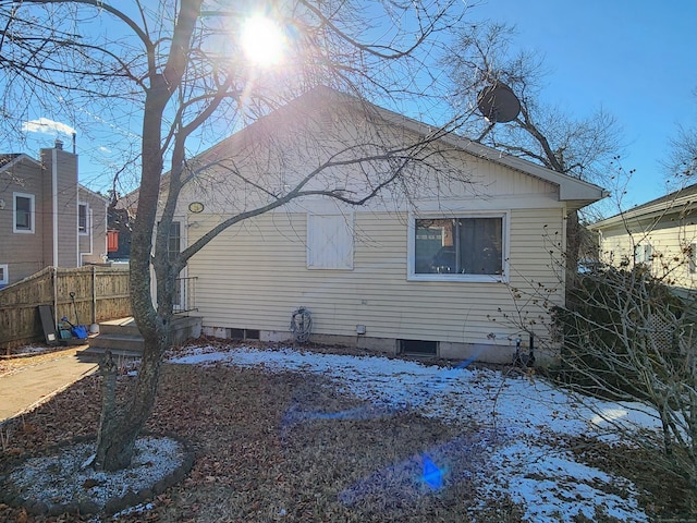 view of snow covered back of property