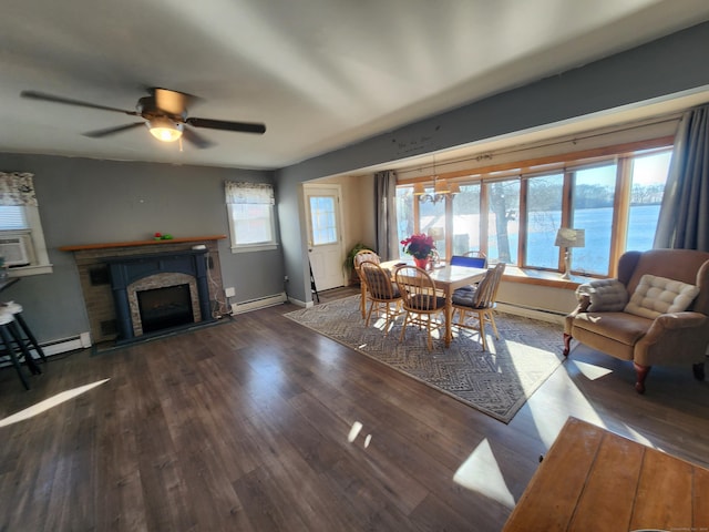 dining space with dark hardwood / wood-style flooring, a water view, a healthy amount of sunlight, and ceiling fan with notable chandelier