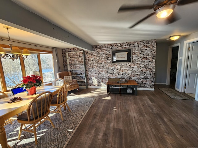 unfurnished dining area with beam ceiling, dark wood-type flooring, and ceiling fan with notable chandelier