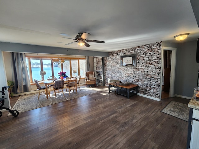 dining room featuring ceiling fan, dark hardwood / wood-style flooring, and a water view