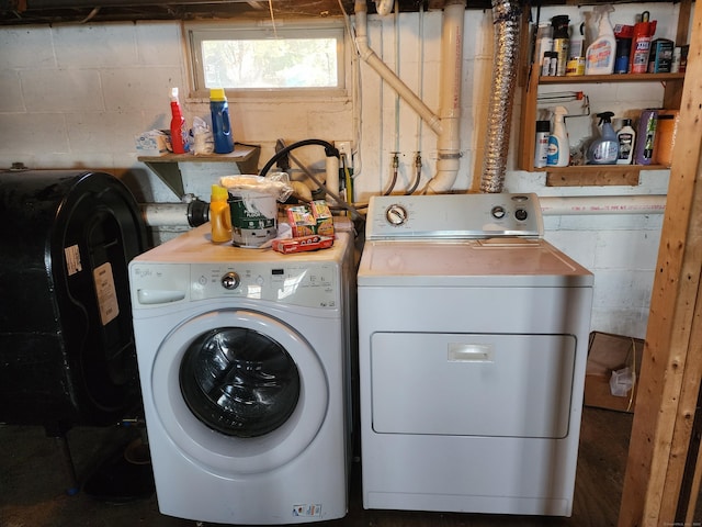 clothes washing area with washing machine and dryer