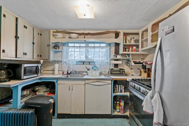 kitchen featuring appliances with stainless steel finishes, a textured ceiling, and sink