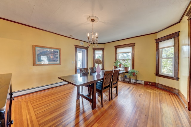 dining space featuring ornamental molding, an inviting chandelier, a baseboard radiator, and light wood-type flooring