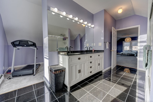 bathroom with vanity and lofted ceiling