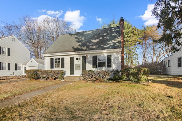 cape cod house featuring a front lawn and a garage