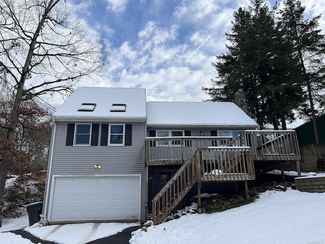 view of front of house featuring a deck and a garage