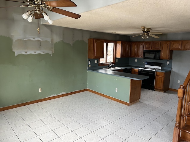 kitchen with black appliances, sink, ceiling fan, a textured ceiling, and kitchen peninsula