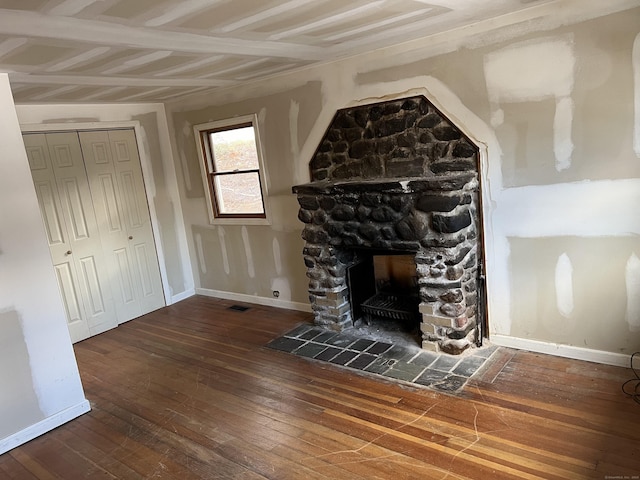 unfurnished living room with dark hardwood / wood-style floors and a fireplace