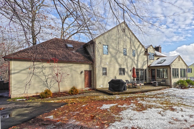 snow covered property with a patio area