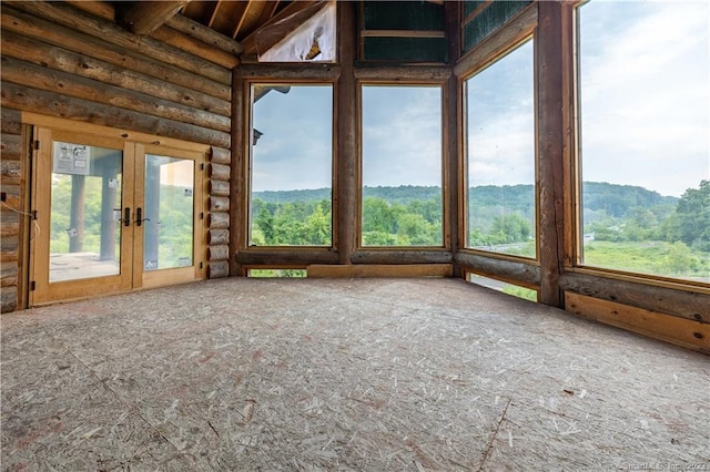 unfurnished sunroom featuring french doors and lofted ceiling