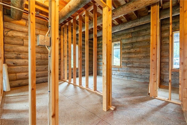 miscellaneous room with rustic walls