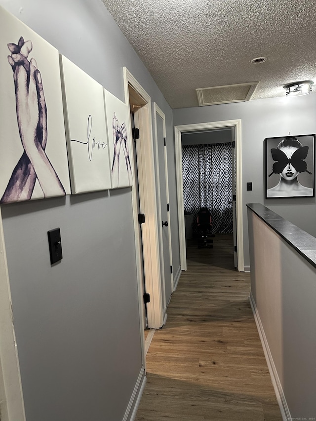 1259 E St Unit A, New Britain, CT 06053 - hall with a textured ceiling, wood finished floors, and attic access
