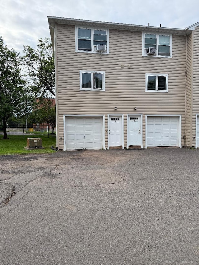 1259 E St Unit A, New Britain, CT 06053 - rear view of house featuring a garage, driveway, and cooling unit
