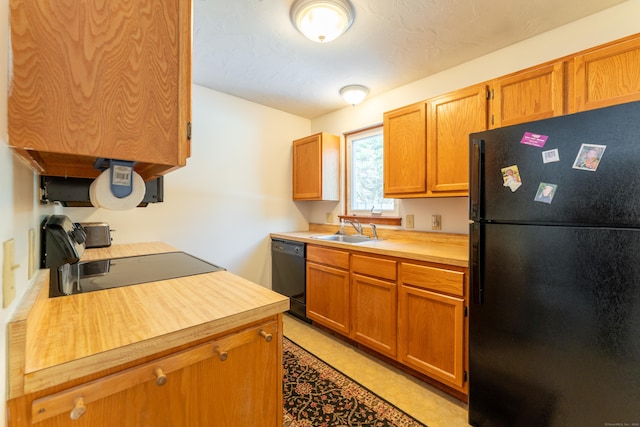 kitchen featuring black appliances and sink