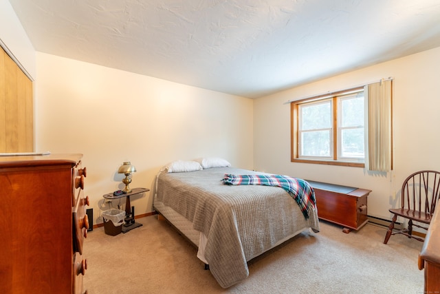 carpeted bedroom featuring a baseboard radiator