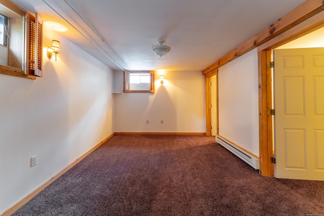 basement featuring dark colored carpet and a baseboard radiator