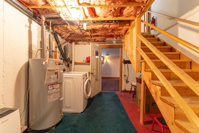 basement featuring washing machine and dryer, electric water heater, and dark colored carpet