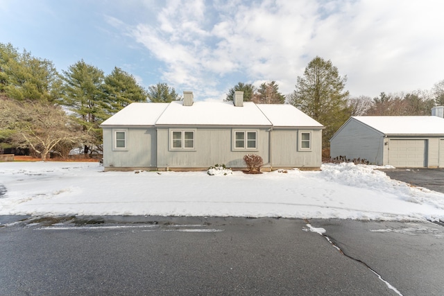 view of front of property featuring a garage and an outdoor structure