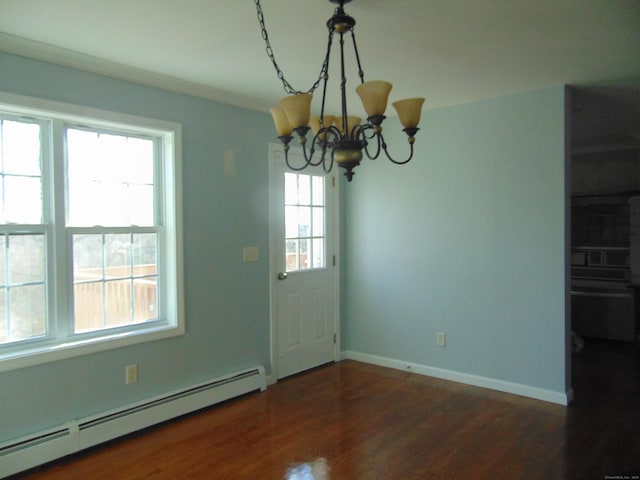 unfurnished dining area featuring ornamental molding, dark hardwood / wood-style floors, baseboard heating, and a notable chandelier