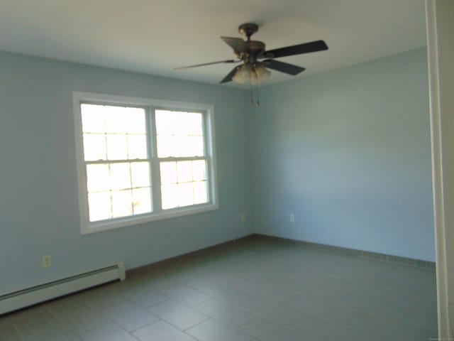 unfurnished room featuring tile patterned flooring, baseboard heating, and ceiling fan