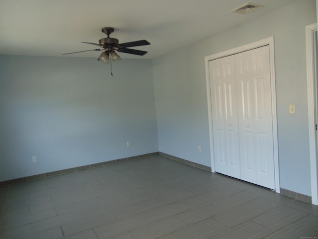 interior space with ceiling fan