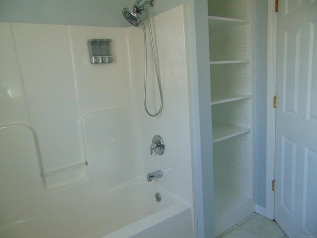 bathroom with tile patterned flooring and shower / bathtub combination