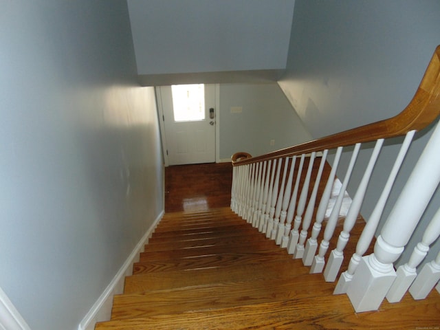 staircase with hardwood / wood-style floors