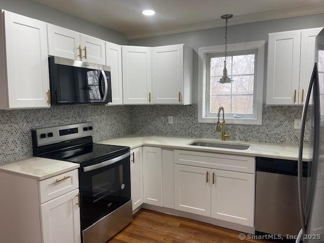 kitchen featuring white cabinets, sink, and stainless steel appliances