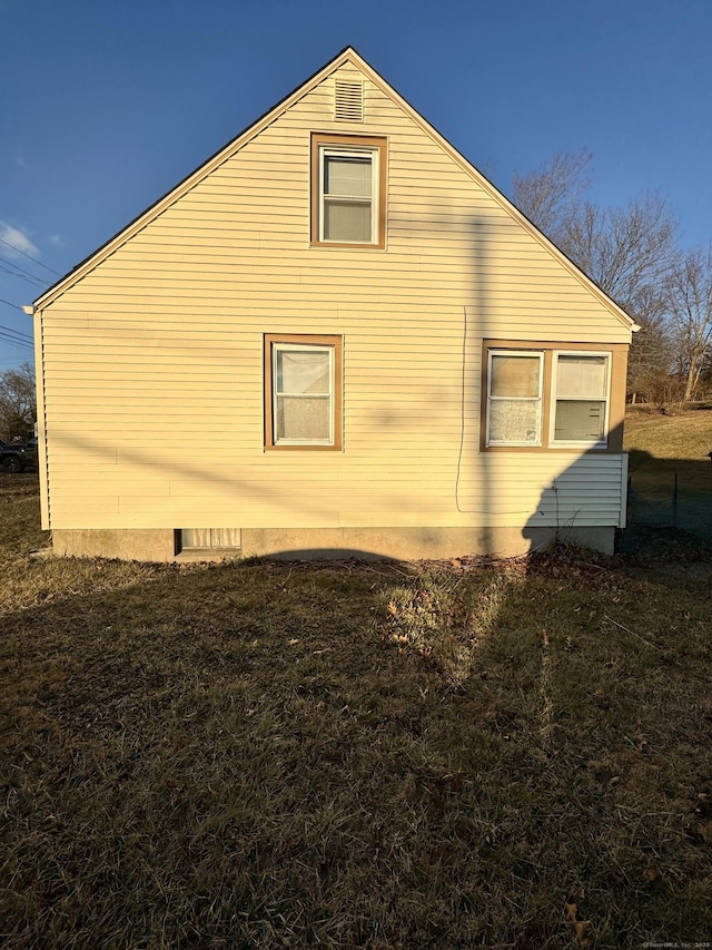 view of side of home with a lawn