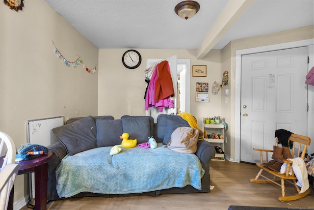 interior space featuring hardwood / wood-style flooring and a textured ceiling