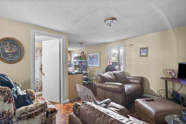 living room featuring a textured ceiling and parquet flooring