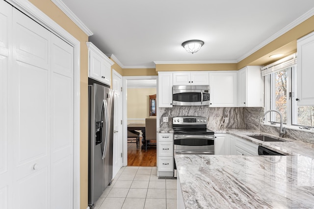 kitchen featuring light stone countertops, sink, appliances with stainless steel finishes, white cabinets, and light tile patterned flooring