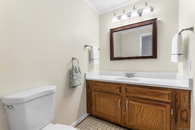 bathroom with tile patterned floors, vanity, toilet, and ornamental molding